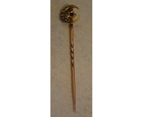 Yellow metal stick pin marked '18ct' to the top section decorated with seed pearl and a single garnet, pin possibly 9ct altho