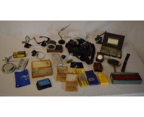 Quantity of watchmakers tools including various small desk vices with magnification, watch parts, tweezers/files, spanner set