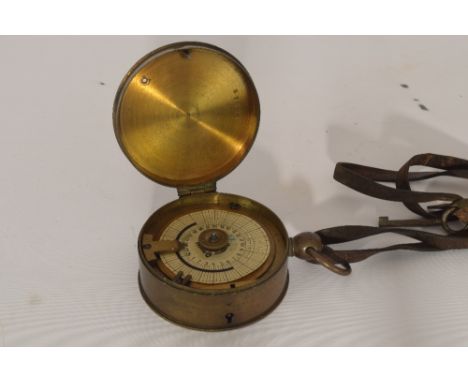Een antieke bronzen wachtmansklok met sleutel. - An antique bronze watchman's clock with key.
