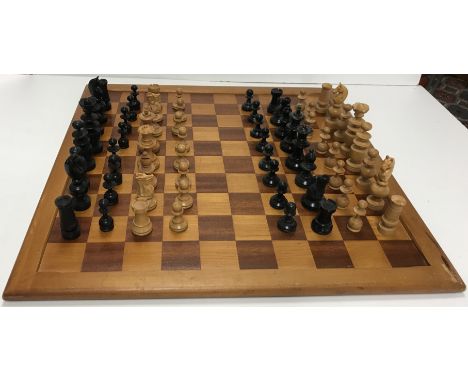 A vintage boxwood and ebonised chess set of turned form, kings 7.9 cm high, together with another similar set, kings 6.7 cm h