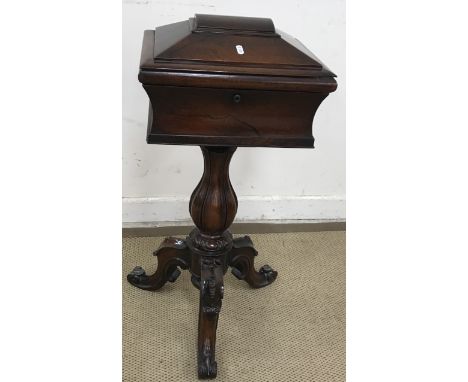 An early 19th Century rosewood teapoy of sarcophagus form opening to reveal a fabric lined interior as a sewing box raised on