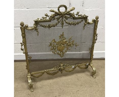 A vintage brass framed fire screen in the Louis XVI taste with wreath and flaming torch and quiver of arrows surmount, the wi