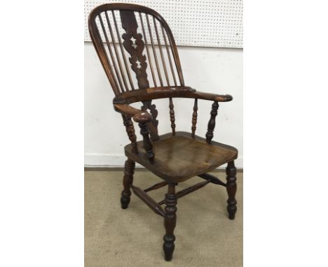A 19th Century Nottinghamshire yew wood and elm stick back elbow chair in the manner of Nicholson of Rockley with shaped seat