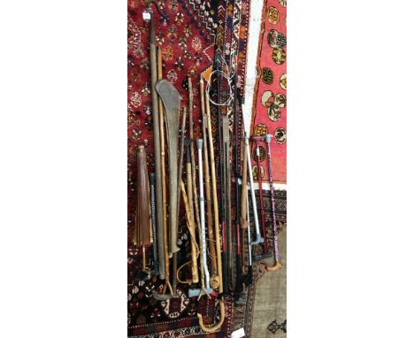 A collection of various thumbsticks, walking sticks, shepherd's crook, rulers, shinty stick etc