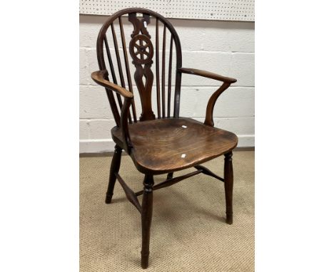 A 19th Century Thames Valley ash and elm wheel and stick back chair, the shaped arms on swept supports to the shaped seat on 