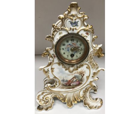 A 19th Century Continental glazed pottery cased Rococo style mantel clock, the movement with circular porcelain dial and cher