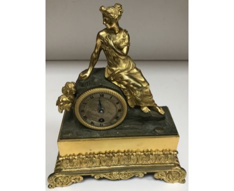 A 19th Century French figural gilt bronze mantel clock decorated with a maiden seated upon a rock, the movement with silvered