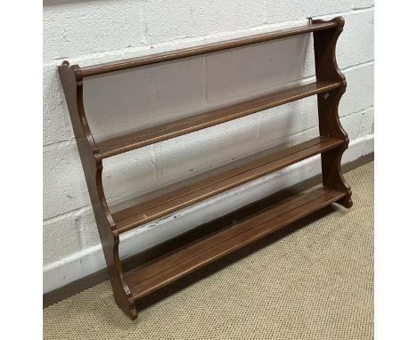 An Ercol elm four tier wall shelf, 94.5 cm wide x 13 cm deep x 71.5 cm high, together with a slightly smaller oak two tier pl