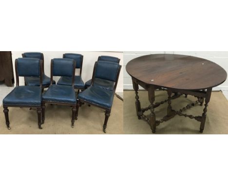 A set of six Victorian walnut framed blue wrexine upholstered scroll back dining chairs, on turned and fluted front legs to b