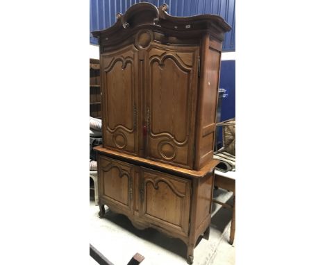 A 19th Century French pitch pine buffet in the Louis XV taste, the scrolling moulded cornice over two shaped fielded panel do