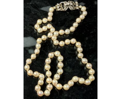 A 1960s cultured pearl single strand necklace with silver mounted paste (simulated diamond) clasp (by RSW, Birmingham 1964), 