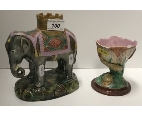 A 19th Century Staffordshire elephant and castle spill vase, 16.5 cm high, together with a Worcester style majolica spill vas