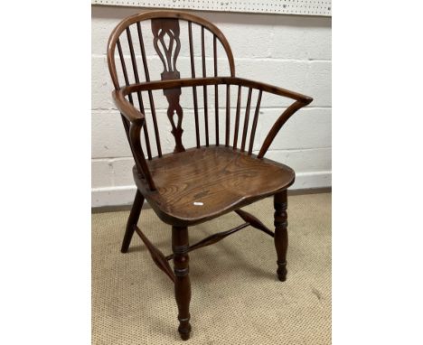 A 19th Century Thames Valley ash and elm stick back elbow chair with fretwork carved back splat, the arms on turned and ringe