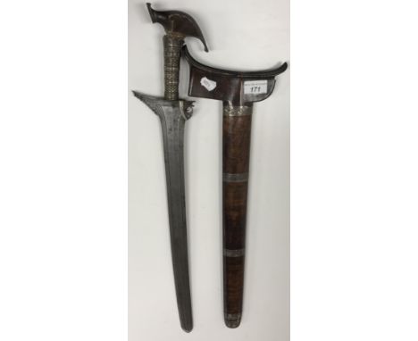 A 19th Century Indonesian (Balinese) executioner's kris / sword with slightly curved folded steel blade and white metal mount