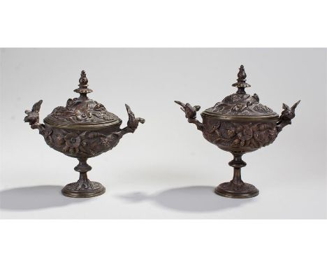 Pair of late 19th Century lidded urns, the acanthus leaf finial tops above flowers and petals, the bases with a pair of birds