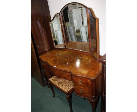 Walnut veneered dressing table, with triple bevelled mirrors above an arrangement of five drawers, on cabriole legs and pad f