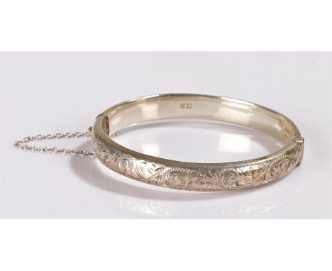 Silver bangle with scroll decoration