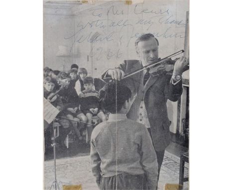 Autographed picture of Yehudi Menuhin, signed in pen, pictured playing the violin in front of a child, 19cm x 25cm