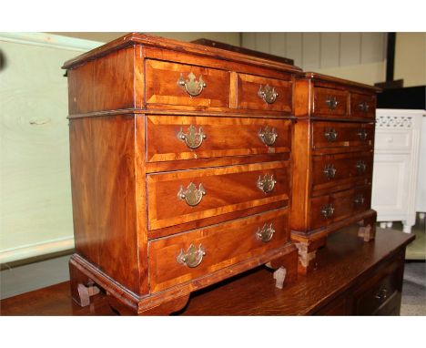 Pair reproduction walnut veneered bedside chests of two short and three long drawers, on bracket feet, 49.5cm wide (2)