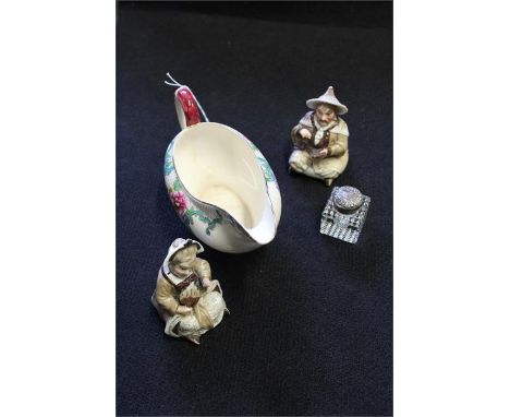 Two early 20th Bisque Porcelain Bobbing / Nodding Head Figures, together with a silver capped inkwell and a pottery sauce boa