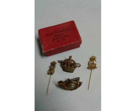 A small vintage box  from a jewellers in Vasteras, Sweden containing two stickpins with the monograms of Swedish Kings, a cap