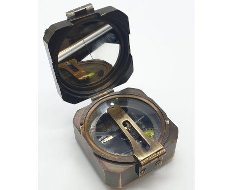A vintage brass compass made by Kelvin and Hughes, London 1917 - in a marine nautical style. 