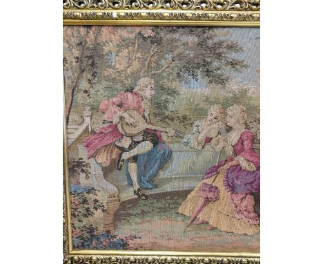 A French Rococo tapestry depicting gaiety in the garden, in a gold baroque style frame. 100 x 54cm. 
