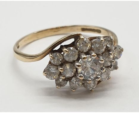 9ct gold cluster ring having crossover gold band. Size Q1/2. 2.8 grams. Full UK hallmark. 