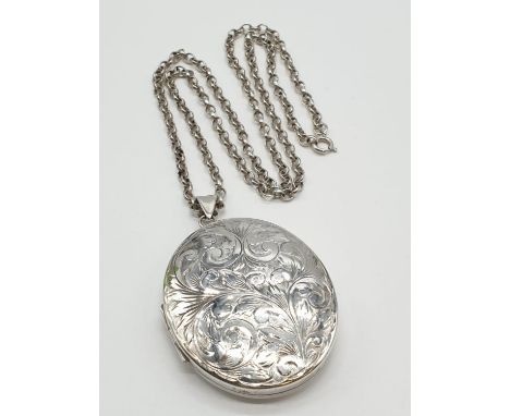 Vintage Large Silver Locket having scroll work to front. Mounted on a long silver belcher type chain. Exceptional condition. 
