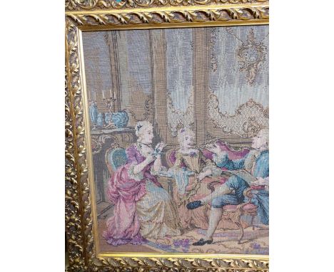 A French Rococo parlour scene tapestry in a gold baroque-style frame. 114 x 62cm. 