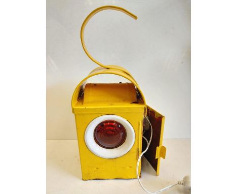 A roadside, road works warming lamp. In working order - plug operated; with amber lens. 13cm x H43cm 