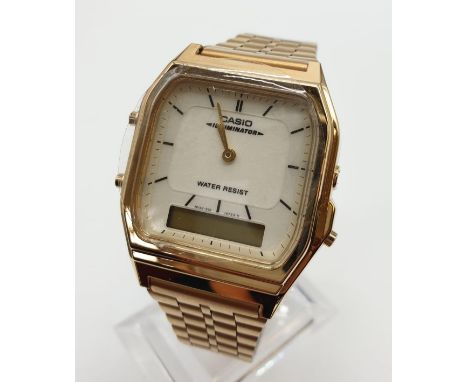 Vintage Cassio wristwatch Illuminator AQ231. New and unused on jewellers Casio display stand. Gold tone brickwork strap, squa