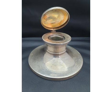 A hallmarked silver Capstan inkwell with original glass liner