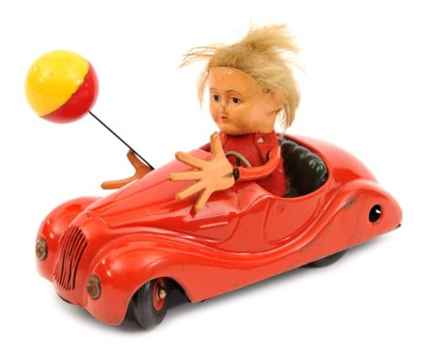 An original issue Schuco Sonny Peter 2006 clockwork car. A tinplate car painted in red with dark green seat, ‘Peter’ figure w