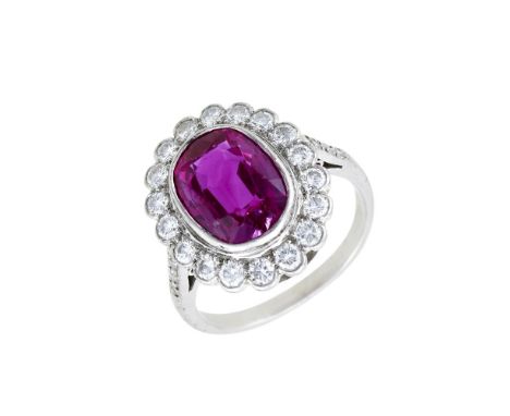 A MID 20TH CENTURY DIAMOND AND RUBY CLUSTER RING, BURMA, NO HEATThe oval cushion cut ruby estimated to weigh 3.50 carats, wit