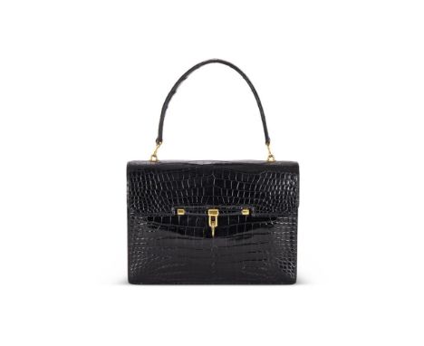 Y HERMÈSA BLACK CROCODILE HANDBAG, CIRCA 1962With a loop handle and a flip lock clasp, the flap opening to a triple gusset in