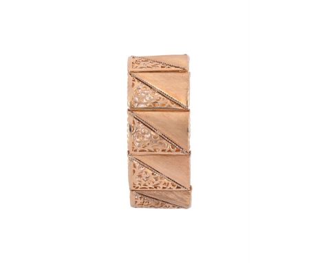 A 1960S GOLD PANEL LINK BRACELETThe rectangular shaped panels with a textured and pierced scrolled decoration, with  an appli