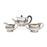 A GEORGE III SILVER THREE PIECE CIRCULAR TEA SET