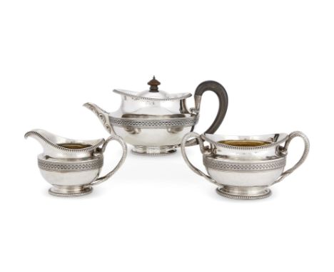 A GEORGE III SILVER THREE PIECE CIRCULAR TEA SETJOHN EMES, LONDON 1805 The tea pot with a wooden finial and loop serpent hand