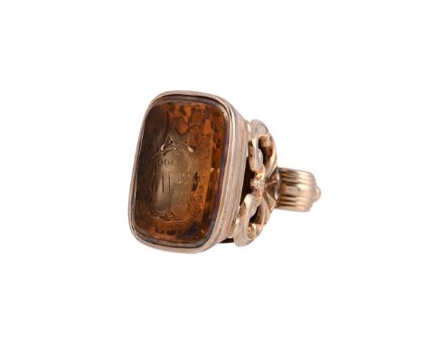 A FIRST HALF OF THE 19TH CENTURY CITRINE FOB SEAL The cushion shaped polished citrine carved with a crest and the motto OMNE 