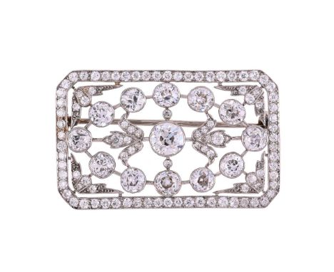 A BELLE EPOQUE DIAMOND PANEL BROOCH CIRCA 1910The rectangular pierced panel set with a central old European cut diamond betwe