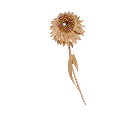 CIVANYAN, PARIS, A RUBY AND DIAMOND FLOWER BROOCHThe flower head with radiating textured and polished petals, the stalked cen