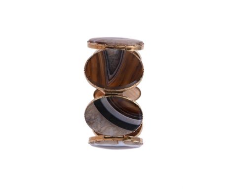 A VICTORIAN AGATE AND GOLD BRACELET CIRCA 1860The polished banded agate panels within gold cut down collet settings, to a con