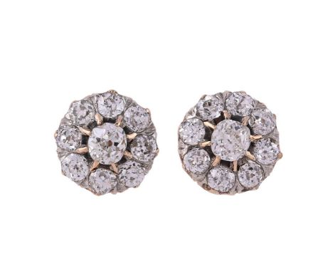 A PAIR OF LATE VICTORIAN AND LATER DIAMOND CLUSTER EAR STUDSThe central old mine cut diamonds with eight claw settings, withi
