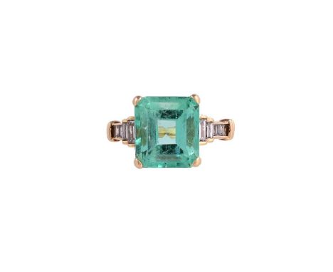 AN EMERALD AND DIAMOND DRESS RINGThe step cut emerald with canted corners estimated to weigh 6.78 carats, to stepped baguette