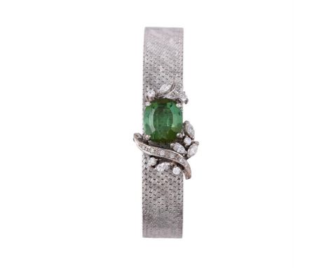 A GREEN TOURMALINE AND DIAMOND BRACELET The cushion shaped green tourmaline with marquise cut and brilliant cut diamond folia