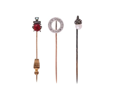 THREE ANTIQUE AND LATER GEM SET STICK PINSThe first with a swinging pearl acorn terminal, with a rose cut diamond cap, circa 