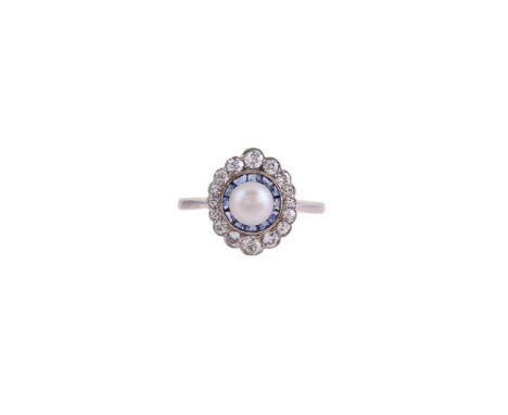 A SAPPHIRE, DIAMOND AND BOUTON PEARL DRESS RINGThe central bouton pearl within a surround of calibré cut sapphires and old mi