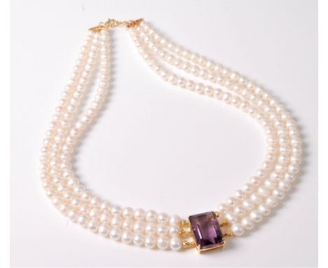 A cultured pearl and amethyst necklace, the central rectangular amethyst, approx. 21 x 16 x 11mm, with three strands of cultu