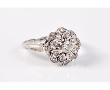 A diamond cluster ring, the central round diamond surrounded by two tiers of smaller diamonds, total estimated weight of diam